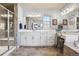 Bathroom featuring a double vanity, updated fixtures, and a glass-enclosed shower at 18984 W 85Th Blf, Arvada, CO 80007