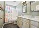 Charming bathroom with double vanity, modern fixtures, and cheerful bird-themed shower curtain at 18984 W 85Th Blf, Arvada, CO 80007