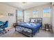 Bright bedroom with blue accents, comfortable bed, and large windows offering ample natural light at 18984 W 85Th Blf, Arvada, CO 80007
