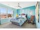 Cozy bedroom featuring a ceiling fan, wooden rocking chair, and a large window with a scenic view at 18984 W 85Th Blf, Arvada, CO 80007