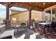 Outdoor covered deck with dining table, grill, and brick features at 18984 W 85Th Blf, Arvada, CO 80007
