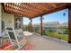 Lovely backyard deck with a pergola, rocking chairs and neighborhood views at 18984 W 85Th Blf, Arvada, CO 80007
