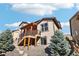Rear exterior of the home featuring a balcony deck and professionally landscaped yard at 18984 W 85Th Blf, Arvada, CO 80007