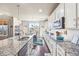 Bright kitchen featuring stainless steel appliances, granite counters and an island at 18984 W 85Th Blf, Arvada, CO 80007