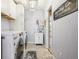 Well-equipped laundry room with a front-loading washer, dryer, and storage at 18984 W 85Th Blf, Arvada, CO 80007
