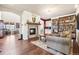 Cozy living room with a fireplace, wood floors, and a large bookshelf at 18984 W 85Th Blf, Arvada, CO 80007