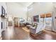 Bright living room with soaring ceilings, large windows, and hardwood floors at 18984 W 85Th Blf, Arvada, CO 80007
