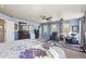 Light filled main bedroom with two seating areas and neutral decor at 18984 W 85Th Blf, Arvada, CO 80007