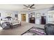 Spacious main bedroom featuring carpet, a ceiling fan and plenty of natural light at 18984 W 85Th Blf, Arvada, CO 80007