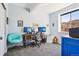 Bright home office featuring a work station and comfortable seating with ample natural light from a large window at 18984 W 85Th Blf, Arvada, CO 80007