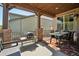 Relaxing covered patio with stylish furniture, grill, and string lights, perfect for outdoor dining at 18984 W 85Th Blf, Arvada, CO 80007