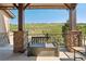 Inviting covered patio featuring comfortable bench seating and scenic views at 18984 W 85Th Blf, Arvada, CO 80007