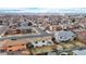 An aerial view of a neighborhood with mountain views, homes with fenced yards, and residential streets at 412 N 10Th Ave, Brighton, CO 80601