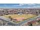 Aerial view showcasing a neighborhood park including a baseball diamond, tennis courts and open play areas at 412 N 10Th Ave, Brighton, CO 80601