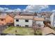 Aerial view of backyard with a lush lawn, mature tree, and patio at 412 N 10Th Ave, Brighton, CO 80601
