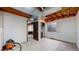 Unfinished basement space with exposed ceiling beams, concrete floors, and open doorway at 412 N 10Th Ave, Brighton, CO 80601