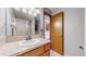 Cozy bathroom with laminate countertops, a shower, and a decorative, framed door at 412 N 10Th Ave, Brighton, CO 80601