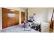 Cozy bedroom featuring a workspace, two closets with panel doors, and neutral carpeting for comfort at 412 N 10Th Ave, Brighton, CO 80601