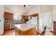Bright kitchen featuring a peninsula island with granite countertops, stainless steel appliances, and wood cabinets at 412 N 10Th Ave, Brighton, CO 80601