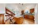 Kitchen featuring a peninsula island with bar stool seating, stainless steel appliances, wood cabinets, and hardwood floors at 412 N 10Th Ave, Brighton, CO 80601