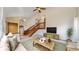 Bright living room with vaulted ceilings, wood staircase, and ample natural light at 412 N 10Th Ave, Brighton, CO 80601