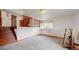Bright living room features carpet floors, natural light, and an open staircase to the upper level at 412 N 10Th Ave, Brighton, CO 80601