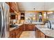 Open kitchen with granite countertops and custom wood cabinetry at 10120 Apache Spring Dr, Conifer, CO 80433