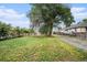 Spacious backyard featuring a lush lawn, mature trees, and a charming picket fence at 150 N 7Th Ave, Brighton, CO 80601