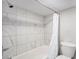 Tiled shower and bath featuring a tiled wall and new toilet at 150 N 7Th Ave, Brighton, CO 80601