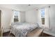 Cozy bedroom with natural light from two windows, complemented by hardwood floors at 150 N 7Th Ave, Brighton, CO 80601