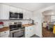 Bright kitchen featuring white cabinets, stainless steel appliances, butcher block countertops, and subway tile back splash at 150 N 7Th Ave, Brighton, CO 80601