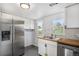 Bright kitchen features stainless steel appliances, white cabinetry, and a butcher block countertop at 150 N 7Th Ave, Brighton, CO 80601