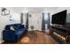 Cozy living room with hardwood floors and a television stand with an electric fireplace at 150 N 7Th Ave, Brighton, CO 80601
