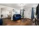 Bright living room featuring hardwood floors, a blue sofa, and modern decor at 150 N 7Th Ave, Brighton, CO 80601