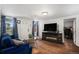 Inviting living room with hardwood floors, a fireplace, and a comfortable blue sofa at 150 N 7Th Ave, Brighton, CO 80601