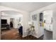 Open-concept living area featuring hardwood floors and arched doorways to kitchen and bonus room at 150 N 7Th Ave, Brighton, CO 80601