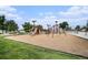 A playground including slides and jungle gyms is on a wood chip bed next to a sidewalk at 150 N 7Th Ave, Brighton, CO 80601