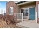 Charming condo entrance with a teal door, brick accents, and low-maintenance landscaping at 2662 S Cathay Way # 110, Aurora, CO 80013