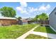 Backyard showcasing a lush green lawn, a shed, and a sturdy wooden fence for added privacy at 2050 S Wolff St, Denver, CO 80219