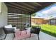 Relaxing backyard patio with stylish furniture and a privacy screen for a serene outdoor experience at 2050 S Wolff St, Denver, CO 80219