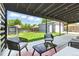 Cozy backyard patio with comfortable seating, a glass coffee table and a view of the yard and garage at 2050 S Wolff St, Denver, CO 80219