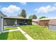 Spacious backyard with a well-maintained lawn, a grill, patio furniture, and a convenient walkway at 2050 S Wolff St, Denver, CO 80219