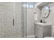 Modern bathroom featuring a sleek shower with elegant tile and a contemporary vanity with stylish fixtures at 2050 S Wolff St, Denver, CO 80219
