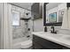Bathroom with tiled shower, new fixtures, and stylish modern finishes at 2050 S Wolff St, Denver, CO 80219
