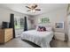 Relaxing bedroom featuring natural light, soft carpet, and minimalist decor at 2050 S Wolff St, Denver, CO 80219