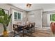 Elegant dining room featuring a modern table with seating, a stylish window and hardwood floors at 2050 S Wolff St, Denver, CO 80219