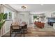 Bright and airy dining room with modern light fixture and natural light, flowing into the living space at 2050 S Wolff St, Denver, CO 80219
