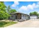 Charming single-story home with gray brick, cozy front porch, detached garage, and a spacious driveway at 2050 S Wolff St, Denver, CO 80219