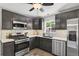 This gorgeous kitchen features modern appliances, sleek cabinets, and beautiful white countertops at 2050 S Wolff St, Denver, CO 80219