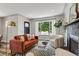 Stylishly decorated living room with modern furniture, fireplace, large windows, and natural light at 2050 S Wolff St, Denver, CO 80219